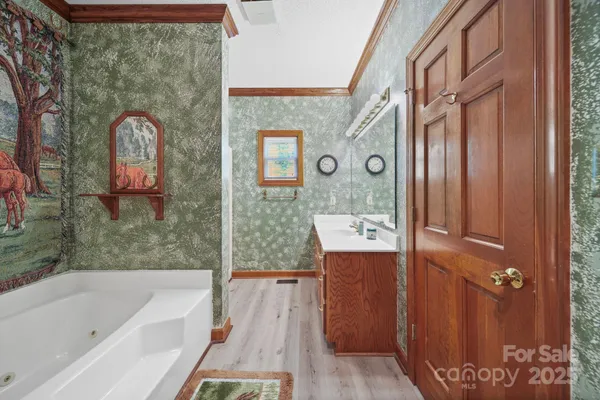 a bathroom with a tub sink and mirror