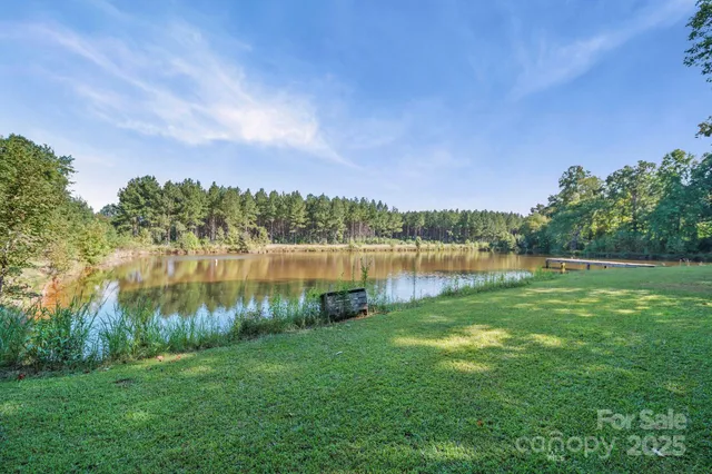 a view of a lake with houses in the back