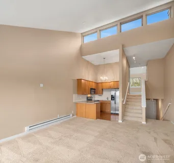 a view of a kitchen with a sink and a refrigerator