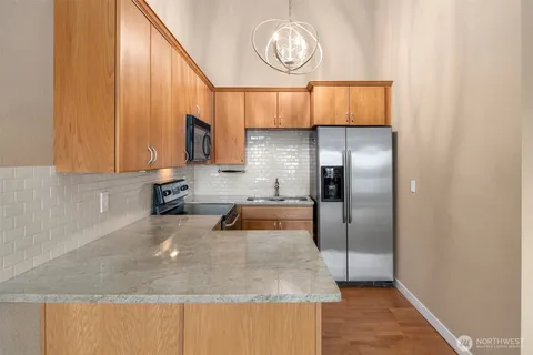 a kitchen with a refrigerator and a sink