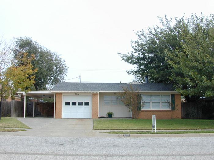 5011 South Milam Street Amarillo, TX 79110 - Photo 1 of 1 a front view of a house with a garden and garage