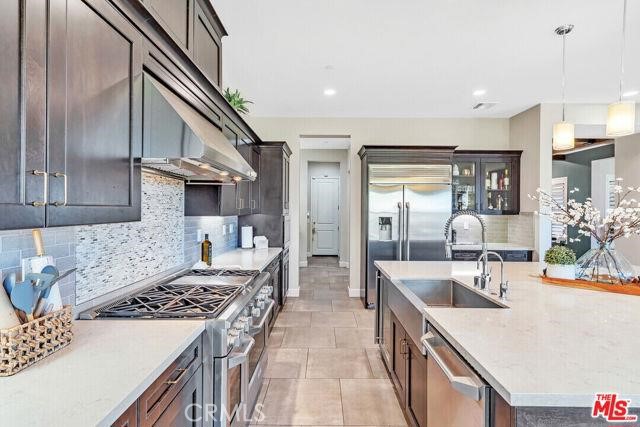 446 Via Maggiore Chula Vista, CA 91914 - Photo 26 of 30 a kitchen with kitchen island a sink stove and refrigerator