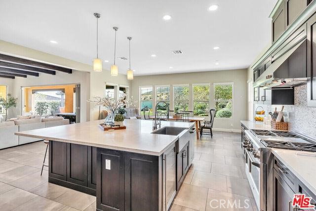 446 Via Maggiore Chula Vista, CA 91914 - Photo 27 of 30 a large kitchen with kitchen island a large island in it