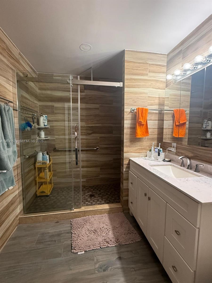 22445 Southwest 264th Street Homestead, FL 33031 - Photo 10 of 12 a bathroom with a shower sink and mirror