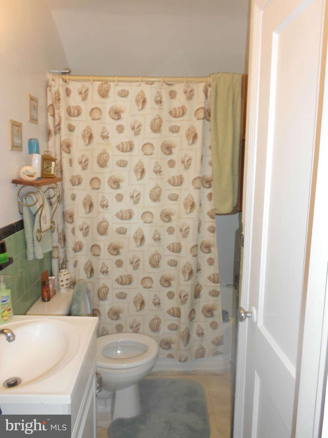 8162 Kavanagh Road Dundalk, MD 21222 - Photo 5 of 5 a bathroom with a toilet and a shower curtain