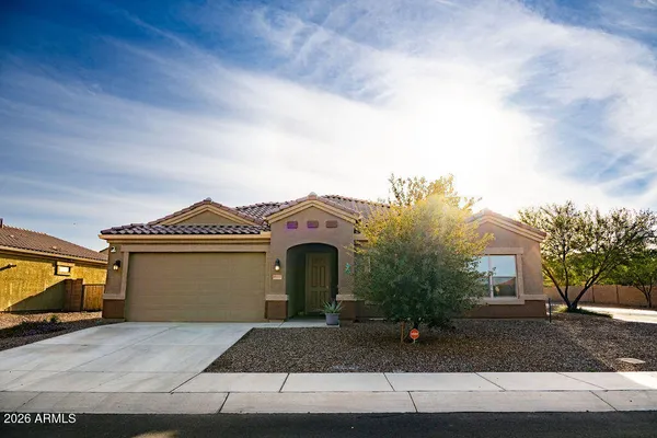 a front view of a house with a yard and garage