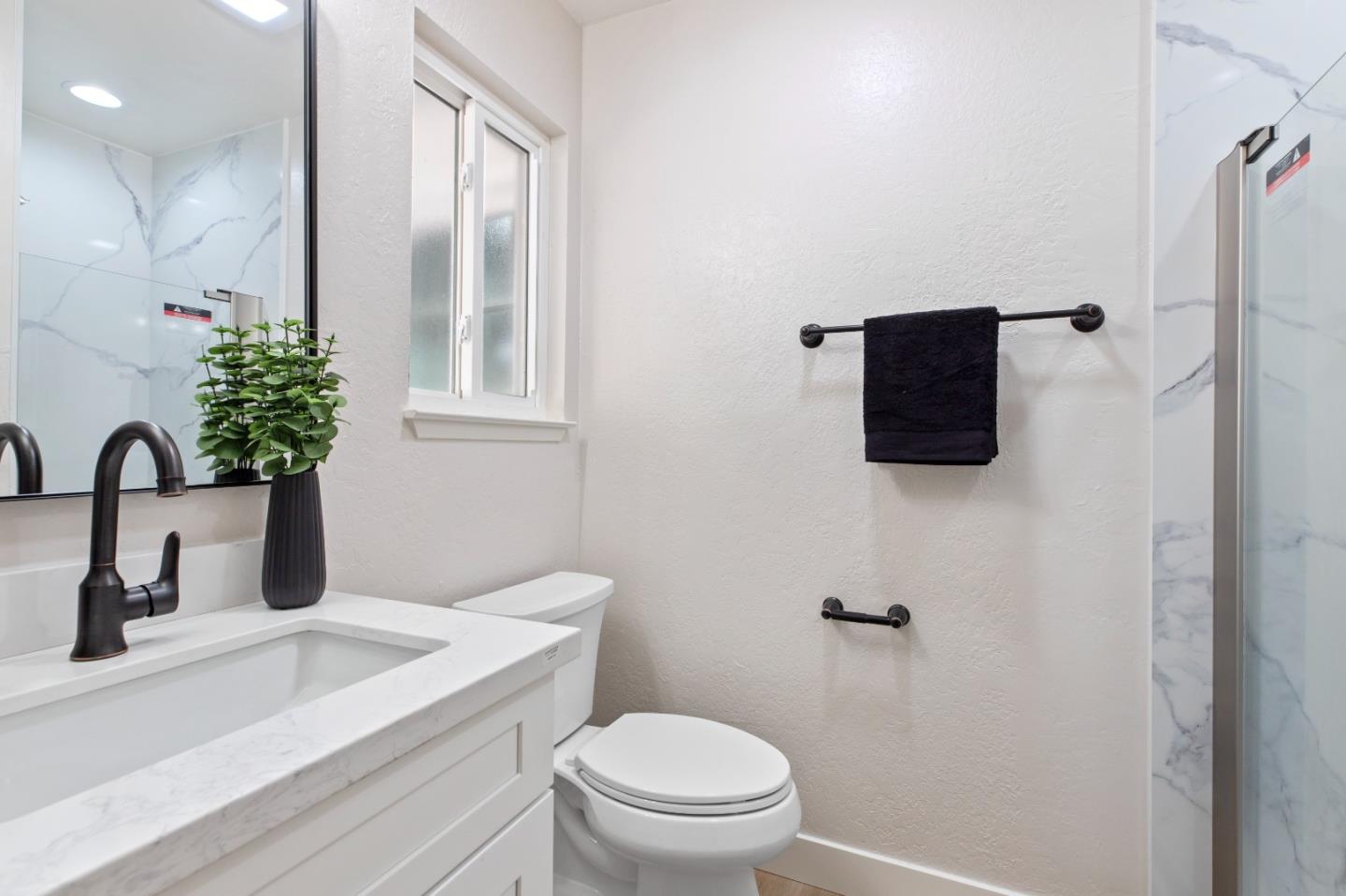 2425 Kildare Lane Modesto, CA 95354 - Photo 18 of 21 a bathroom with a toilet sink and mirror