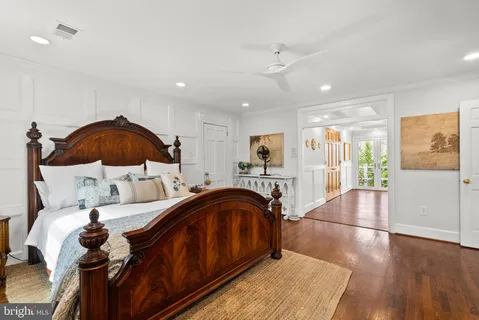 a bedroom with furniture and wooden floor