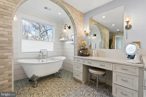 a spacious bathroom with a sink and a mirror