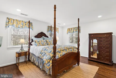 a bed sitting in a bedroom next to a window