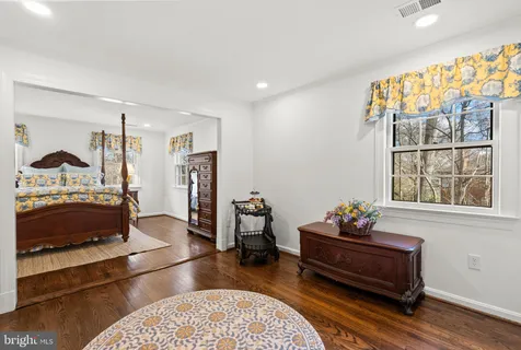 a bedroom with furniture and a window