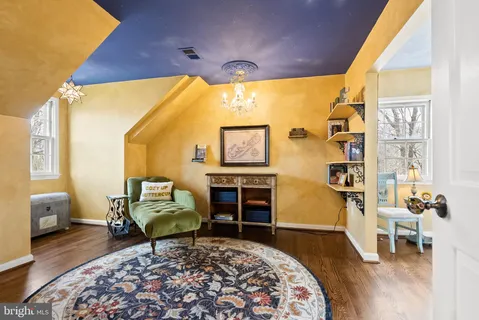 a living room with furniture a rug and a large window