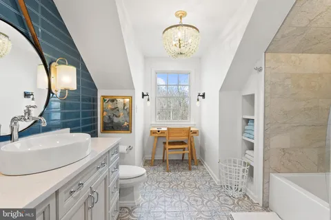 a bathroom with a sink a toilet a mirror and bathtub