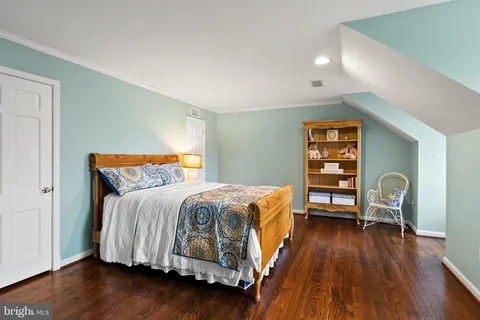 a bedroom with a bed and a chair