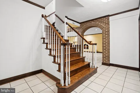 a view of entryway with stairs and wooden floor