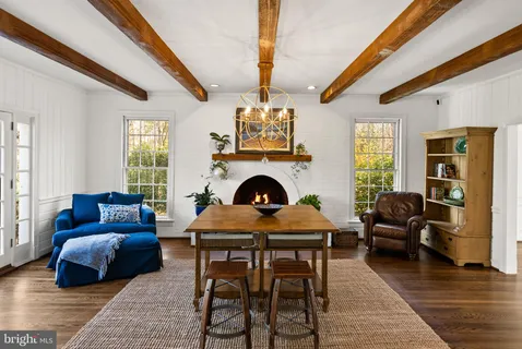 a living room with furniture a fireplace and a chandelier