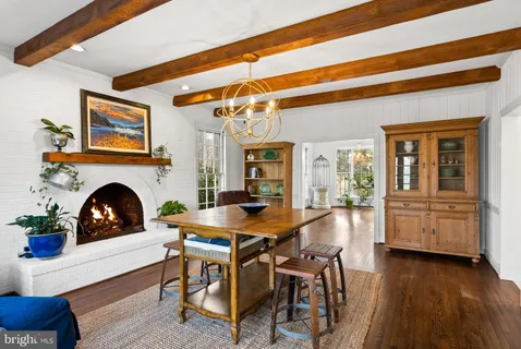 a dining room with furniture and wooden floor