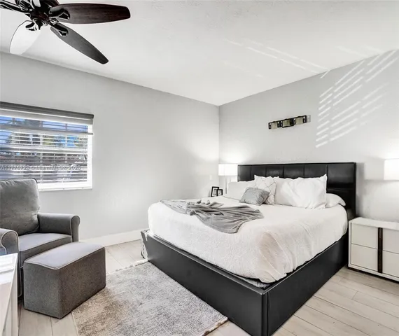 a large bedroom with a bed and window