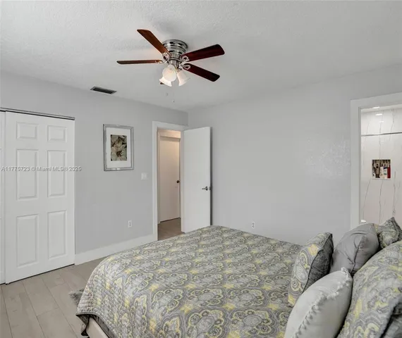 a bedroom with a bed and cabinets