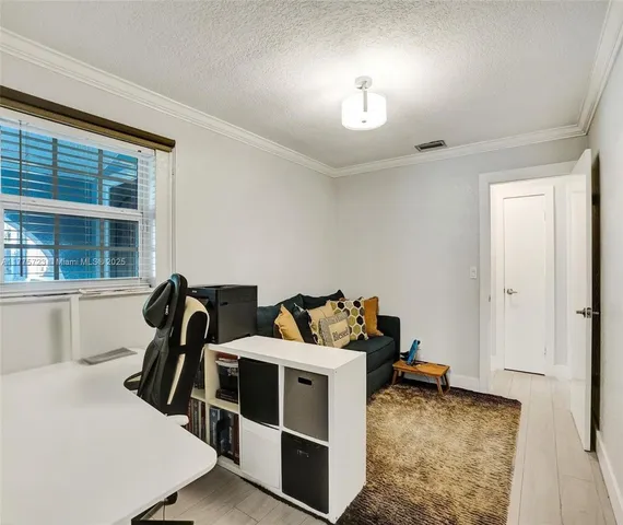 a view of a livingroom with furniture and windows