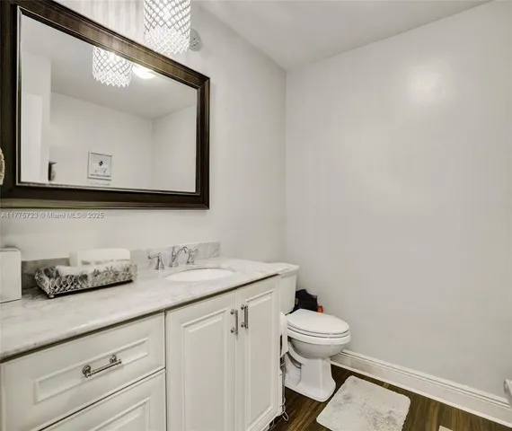 a bathroom with a toilet a sink and mirror