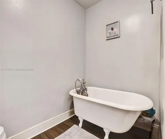 a white bath tub sitting next to a white sink