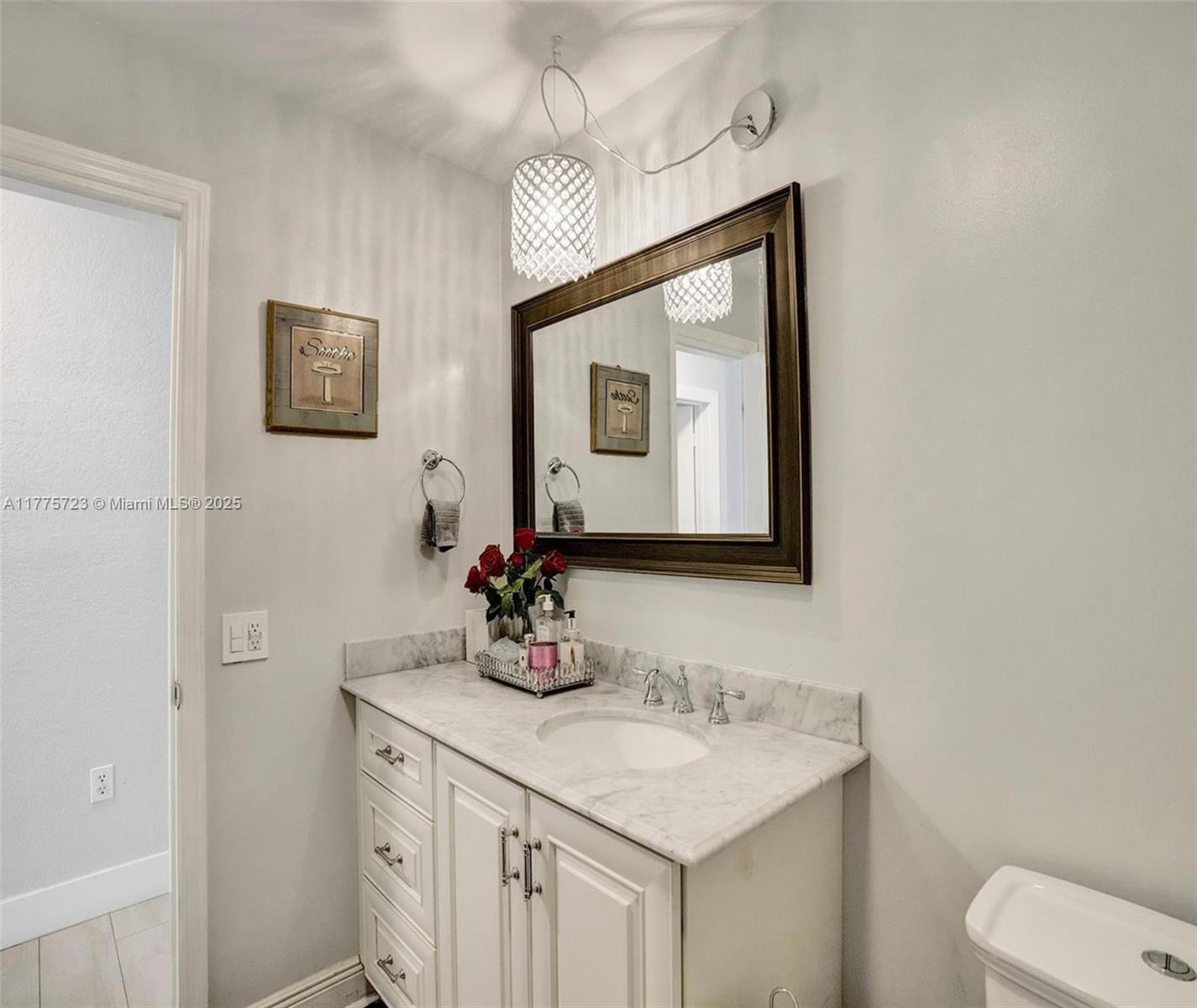 217 Southeast 5th Street Dania Beach, FL 33004 - Photo 23 of 26 a bathroom with a toilet sink and mirror