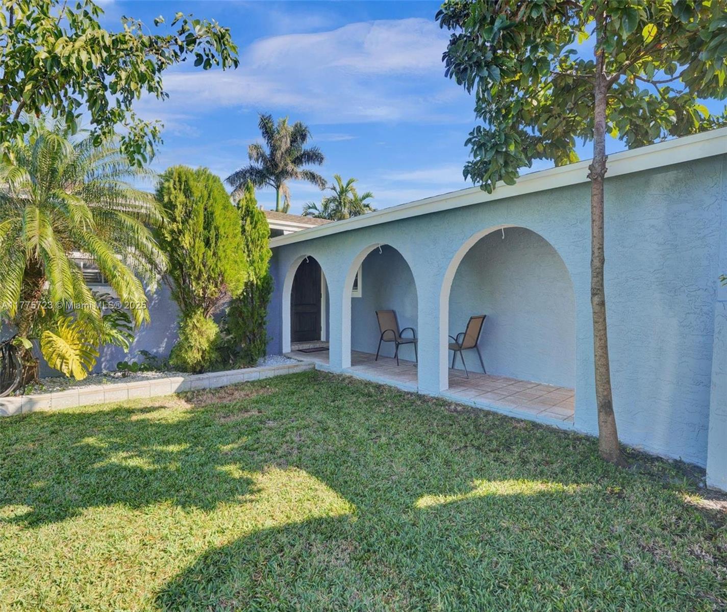 217 Southeast 5th Street Dania Beach, FL 33004 - Photo 24 of 26 a view of a yard in front of a house with a garden