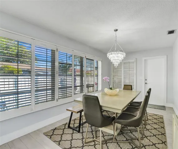 a view of a dining room with furniture window and outside view