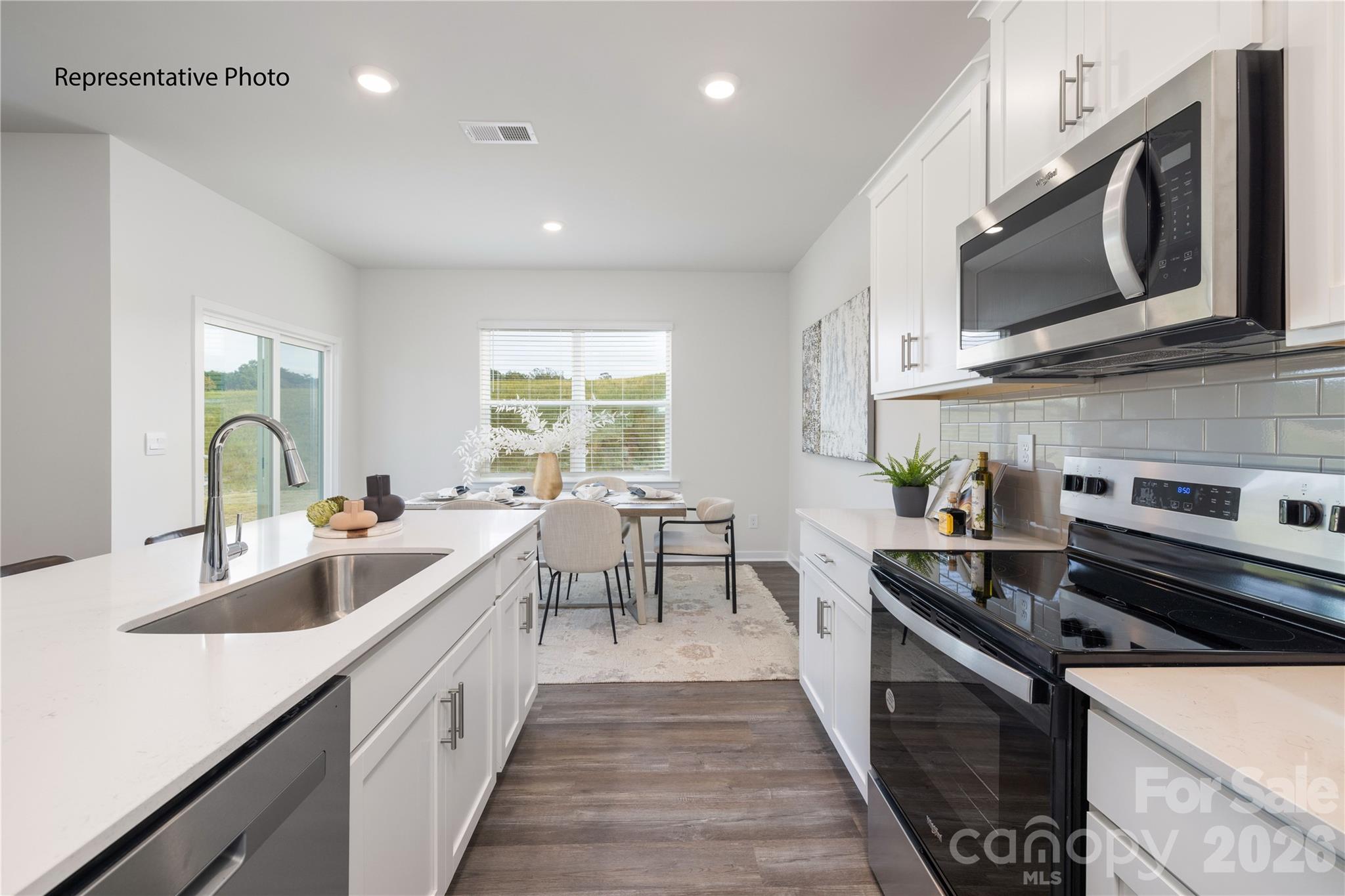 1406 Mammoth Road Hickory, NC 28602 - Photo 11 of 24 a kitchen with stainless steel appliances a sink dishwasher stove microwave and cabinets