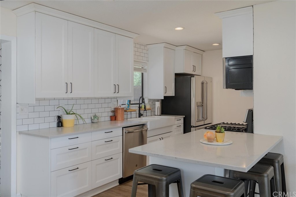 89 Glen Cir Drive Oroville, CA 95966 - Photo 8 of 32 a kitchen with a table chairs and a refrigerator