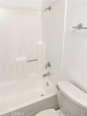 a bathroom with a bathtub and a toilet