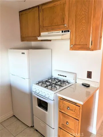 a white stove top oven sitting inside of a kitchen