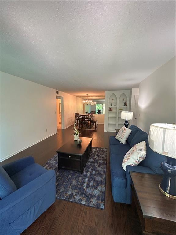 6851 Roswell Road, Unit O10 Atlanta, GA 30328 - Photo 14 of 20 a living room with furniture and wooden floor