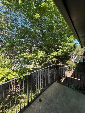a balcony with trees in front of it