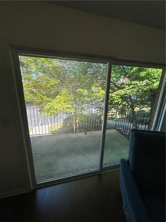 6851 Roswell Road, Unit O10 Atlanta, GA 30328 - Photo 17 of 20 a view of empty room with wooden floor and floor to ceiling window