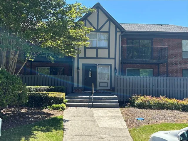 a view of a house with backyard and porch area