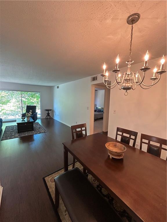 6851 Roswell Road, Unit O10 Atlanta, GA 30328 - Photo 3 of 20 a view of a dining room with furniture and chandelier
