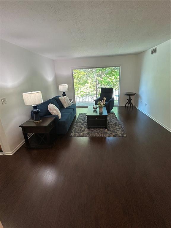 6851 Roswell Road, Unit O10 Atlanta, GA 30328 - Photo 5 of 20 a living room with furniture and a large window