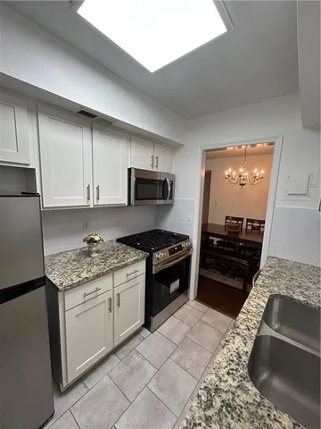 a kitchen with a stove and a refrigerator