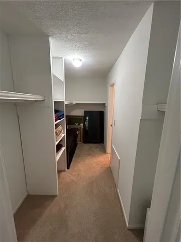 a view of empty room with refrigerator