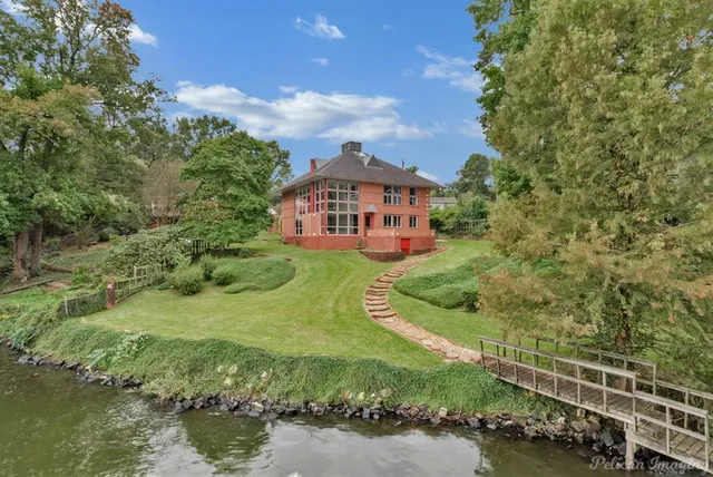 a living room with furniture and large windows