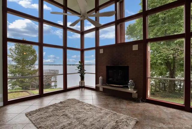 a kitchen with stainless steel appliances granite countertop a refrigerator a sink dishwasher a stove and a dining table with wooden floor