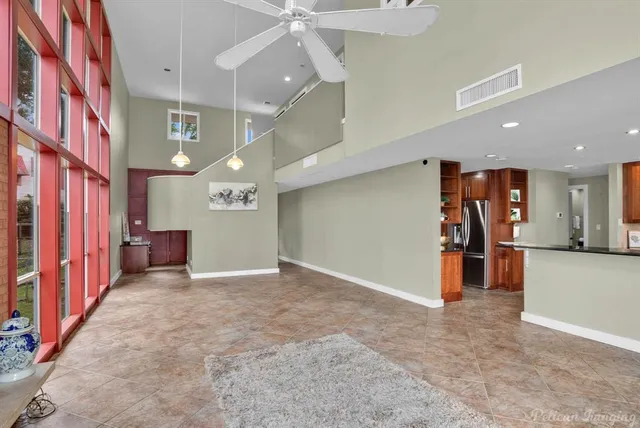 a kitchen with stainless steel appliances granite countertop a refrigerator and a wooden floor
