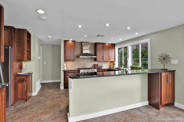a bathroom with a sink a mirror and a potted plant