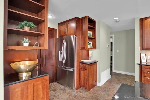 a view of a big room with a chandelier fan and a window