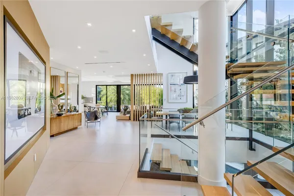 a living room with furniture and large windows