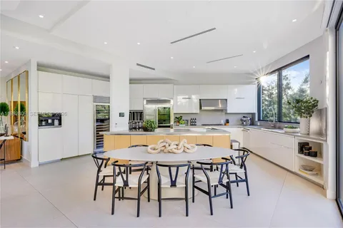 a large white kitchen with a large window