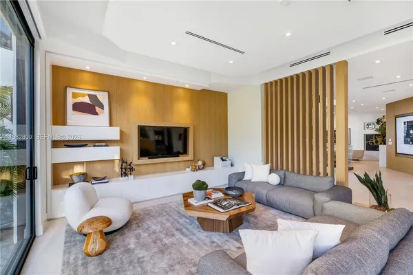 a bedroom with furniture and large windows