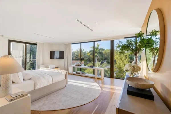 a spacious bedroom with a bed and a couch